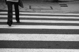 person walking across a pedestrian crosswalk