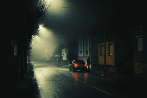 car driving down a dark road