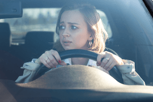 Anxious woman behind the wheel 