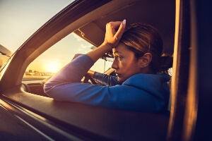 stock image of young female driver not feeling well