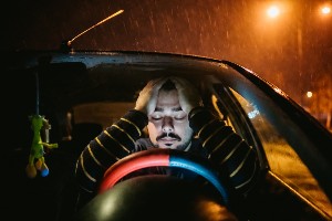 upset male driver on a rainy night