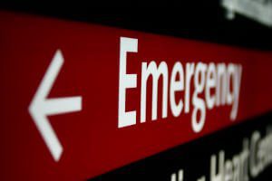 sign pointing to emergency room entrance